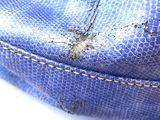 a close up of a blue purse with a hole in it