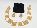 un ensemble composé d'un collier et de boucles d'oreilles en or, présenté dans une pochette en velours
