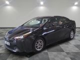 the toyota prius is parked in the garage on a checkered floor