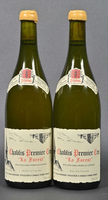 two bottles of wine sitting next to each other on top of a table