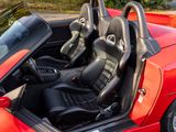 a red sports car with black leather seats in the back
