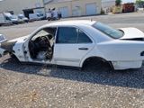 a white car that is sitting in a lot