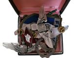 a box that has a brooch in it with a picture of an eagle