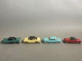 several toy cars are lined up in a row on a gray surface