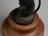 statue of a mouse on a wooden base on a white background