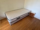 a mattress on the floor in the corner of a room