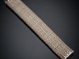 a close up of a silver bracelet on a black background