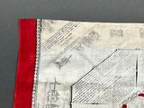 a red and white piece of fabric with a picture on it