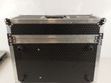 a close up of a black and silver case on a white surface