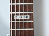a close up of a guitar neck with a number on it