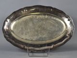 a silver tray with a silver handle on a stand