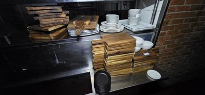 many plates and bowls on the counter in the kitchen