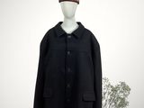black coat with a red pom pom on top of a mannequin head