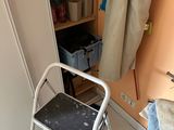 a small step stool in the corner of a room