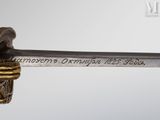 an old sword with a gold handle on a white background
