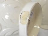 a white vase that has a tag on it