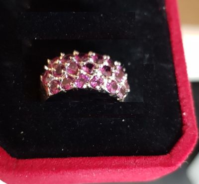 a close up of a pink diamond ring in a black box
