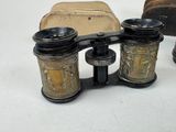 a pair of binoculars sitting on a table next to a bag