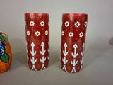 two vases sitting next to each other on a table