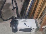 a white box with a black handle sitting on the floor
