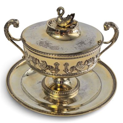 an antique silver plate with a bowl and saucer on it