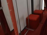 a room with a red carpet and a mirror