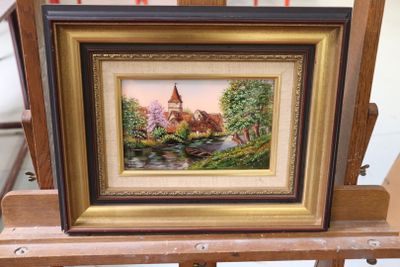 a picture of a painting of a church on a easel