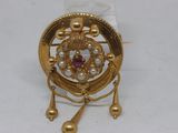 an image of a close up of a broochle on a white surface