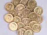 a pile of gold coins on a white surface