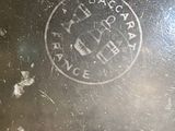 a close up of a metal pan with a stamp on it