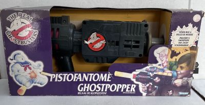 a box with a toy gun in it on a table