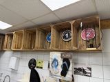 many wooden crates on the wall above a sink