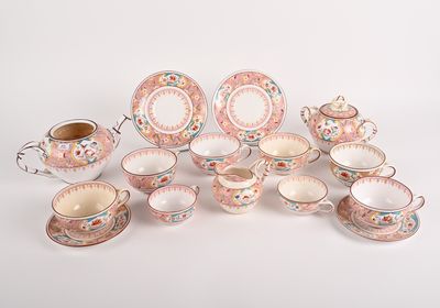 a group of porcelain dishes and cups on a white surface