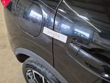 a car with a sticker on the side of it ' s door