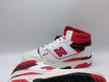 a pair of white and red sneakers on a white surface