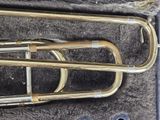 a brass instrument in a case on the floor