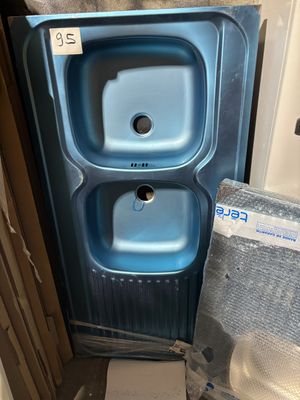 a blue sink and a toilet in a small room