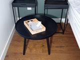 a small table with a book on it in the corner of a room