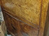 a wooden cabinet that has a drawer on top of it