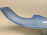 a blue glass bowl on a glass stand on a table