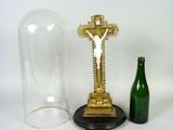 a gold cross and a bottle of wine next to it