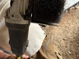 a man that is using a power drill on a piece of wood