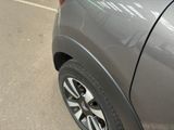 a close up of a car ' s tire on the side of the road