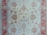 a red and white rug with a floral design on it