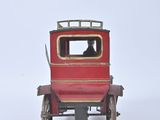 a red toy car sitting on a white surface