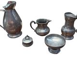several pieces of antique silverware including a pitcher, bowl, and spoon