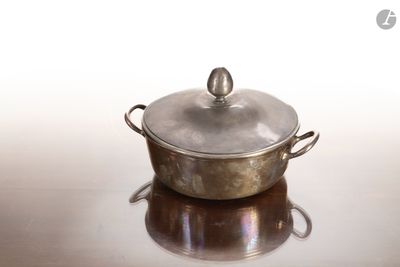 une casserole en argent avec un couvercle, posée sur une table