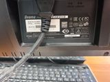 a laptop with a cable connected to it on a desk
