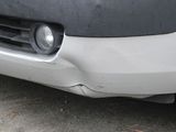 a close up of the front bumper of a white van