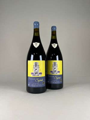 two bottles of wine sitting next to each other on a table